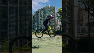 Riding A Bike Across A Tennis Net